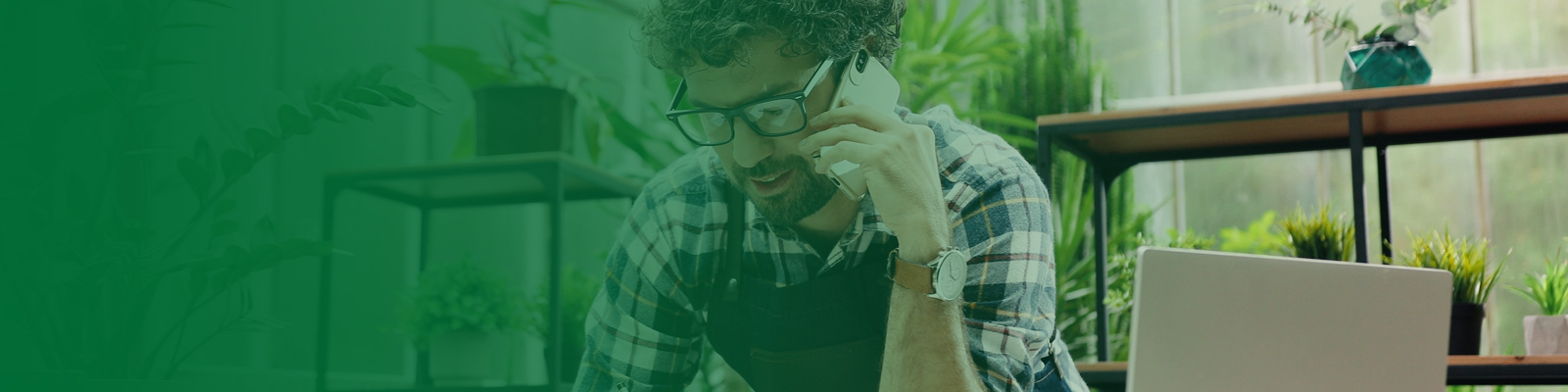 plant shop owner on phone with green overlay