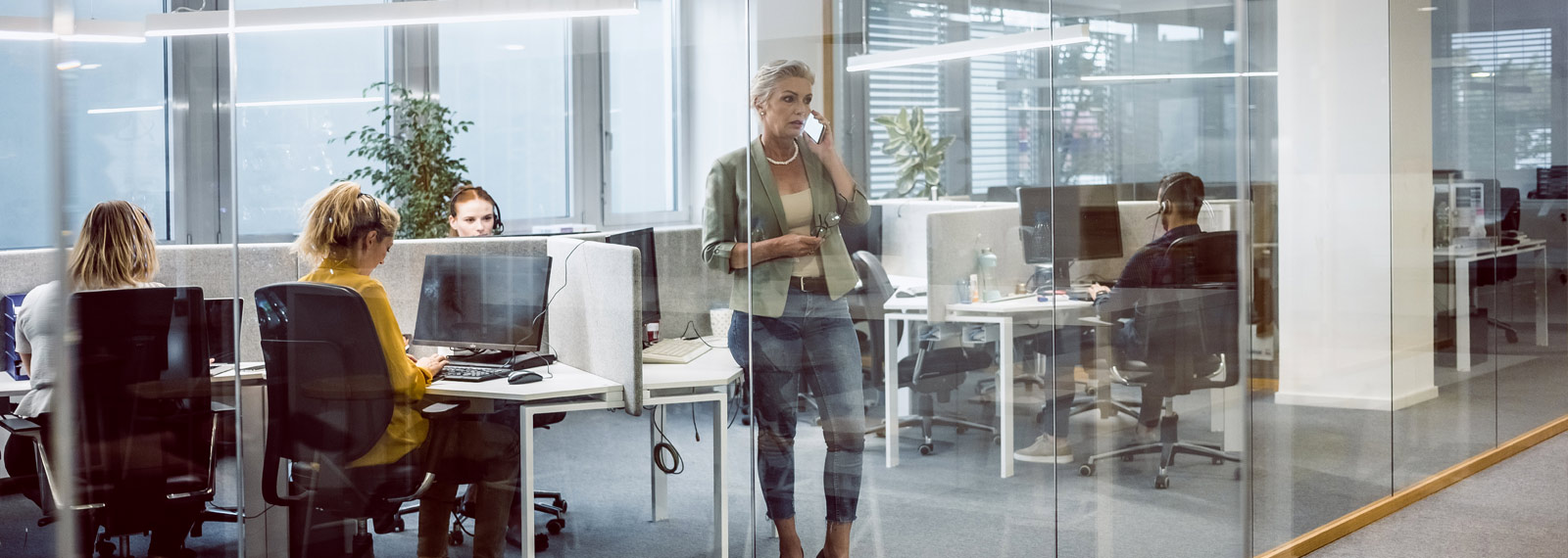 sales people and office workers at computers in office