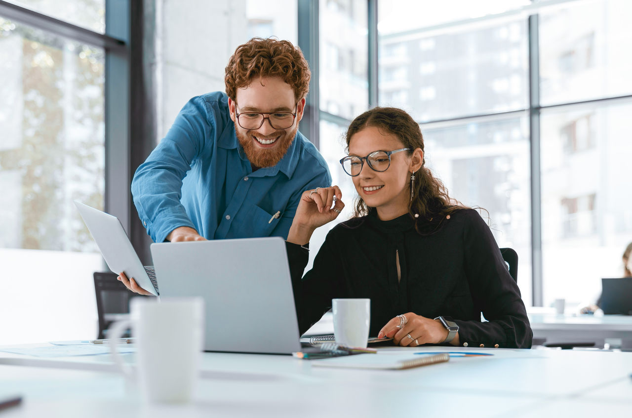 Two business colleagues using a laptop.