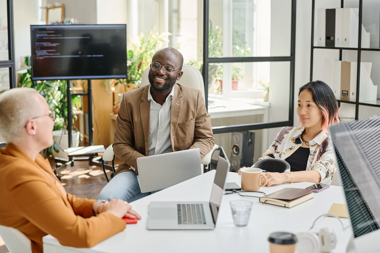 Team of programmers sitting at table