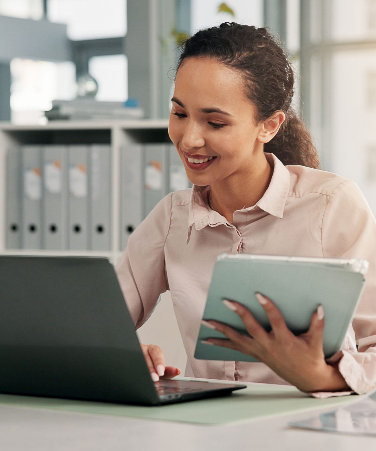 Image of women in office working on computer and tablet
