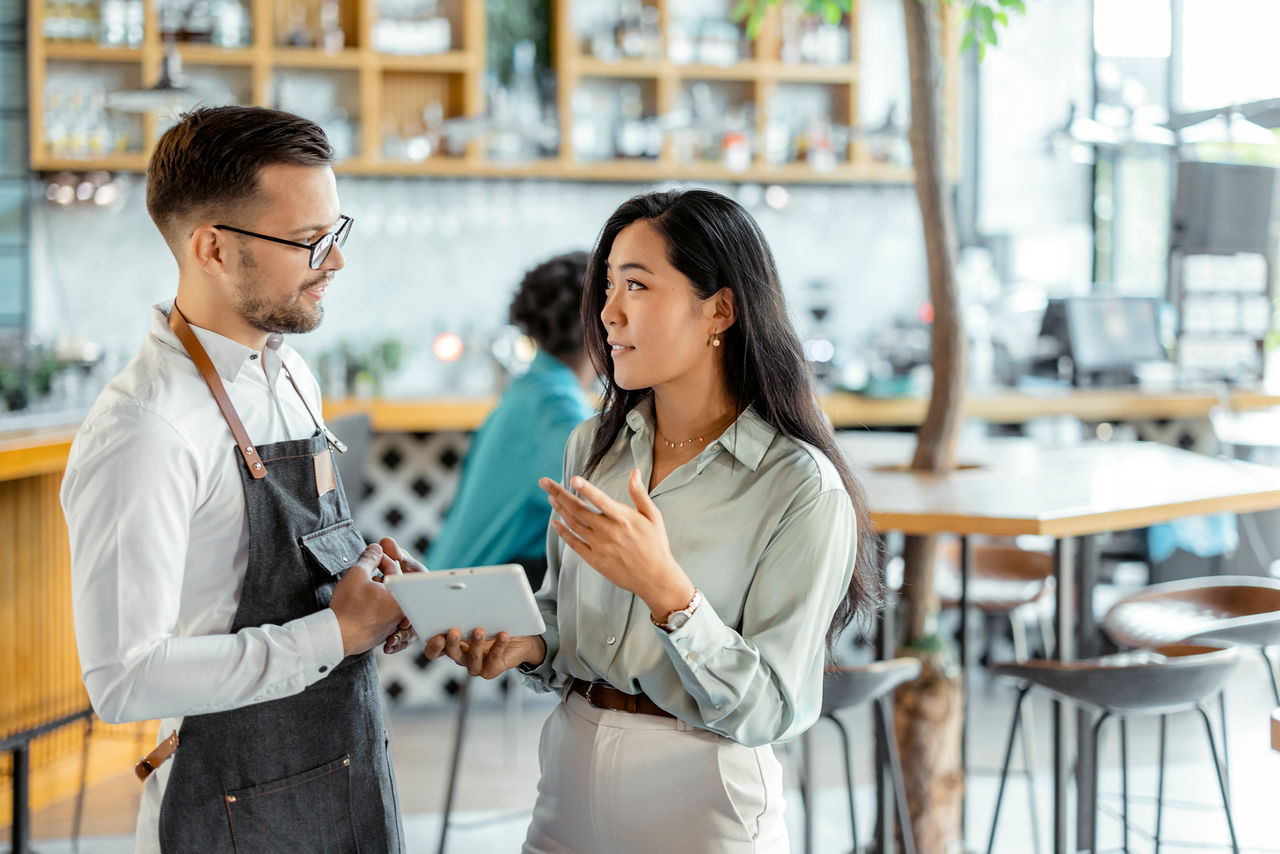 Lender speaking with small business owner of a cafe
